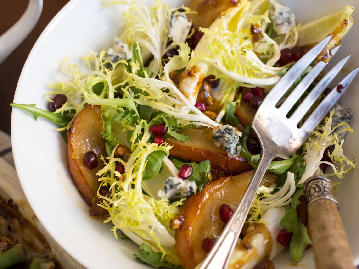 Roasted Pear Salad With Endive, Pomegranate, Blue Cheese, and Hazelnut Vinaigrette Recipe Image